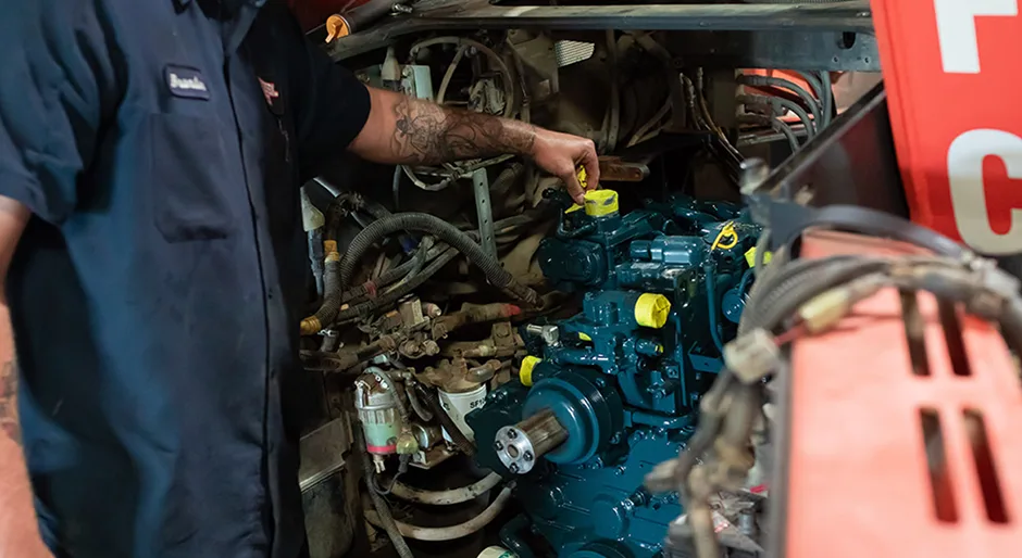 Diesel Pros technician working on an exposed commercial diesel engine