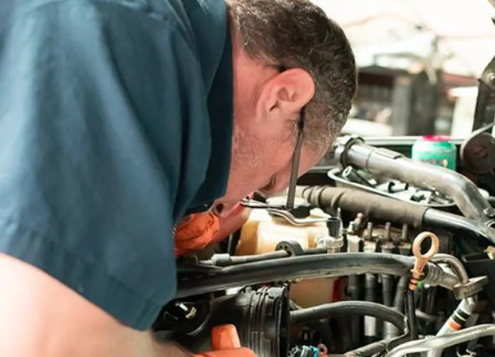 Diesel Pros technician servicing the engine of a personal diesel truck