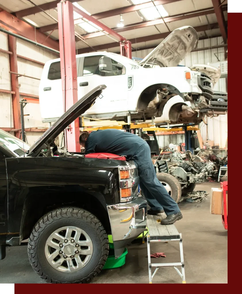 Diesel Pros technician working on a pickup truck in the Hurst, TX shop