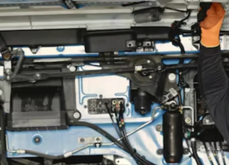 Diesel Pros technician working under a truck on drivetrain and undercarriage components