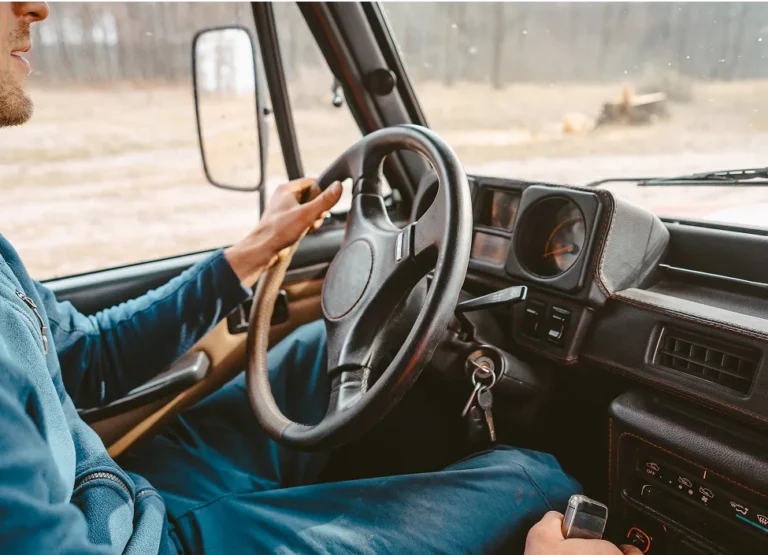 Driver behind the wheel of a diesel truck on a rural road